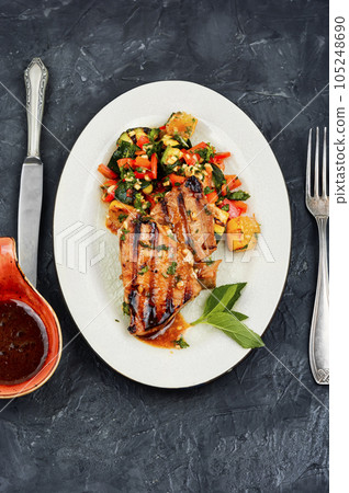 Tuna steak fried with grilled vegetables. 105248690
