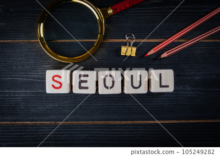 SEOUL. City name from alphabet letters on dark wood texture background SEOUL. City name from alphabet letters on dark wood texture background 105249282