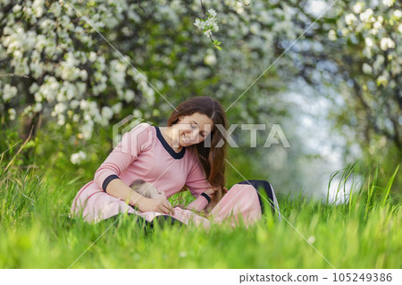 mother and daughter sitting outdoors mother and daughter sitting outdoors 105249386