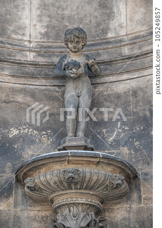 Old sculpture of a bathing child and shell at the fountain in historical and museums downtown of Dresden Old sculpture of a bathing child and shell at the fountain in historical and museums downtown of Dresden 105249857