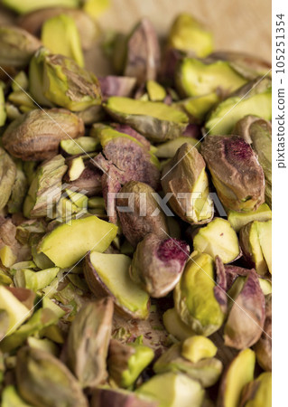 Crispy delicious pistachios with salt on the table Crispy delicious pistachios with salt on the table 105251354