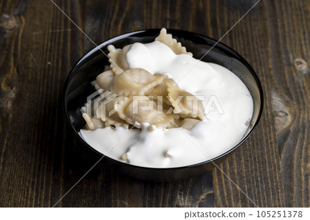 Sour cream covered dumplings with meat Sour cream covered dumplings with meat 105251378
