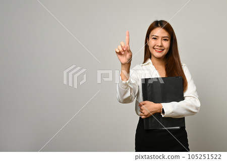 Beautiful asian woman office worker finger empty space isolated on gray background 105251522