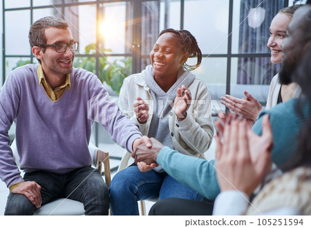 Happy business people sit on chairs shot from above. 105251594