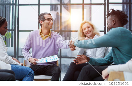 Businesspeople sitting with documents on stage and talking in hub 105251691