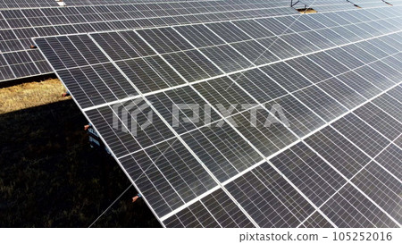 Solar power plant. Flight over modules of solar power station on sunny day. Renewable electrical energy. Photovoltaic modules photobatteries. New modern technology. Alternative green electricity power Solar power plant. Flight over modules of solar power station on sunny day. Renewable electrical energy. Photovoltaic modules photobatteries. New modern technology. Alternative green electricity power 105252016