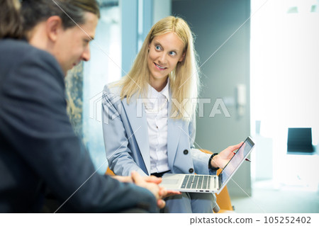 Business meeting. Client consulting. Confident business woman, real estate agent, financial advisor explaining details of project or financial product to client in office 105252402