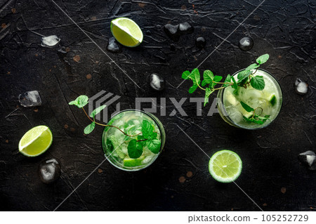 Mojito cocktail. Summer cold drink with lime, fresh mint, and ice. Cool beverage 105252729