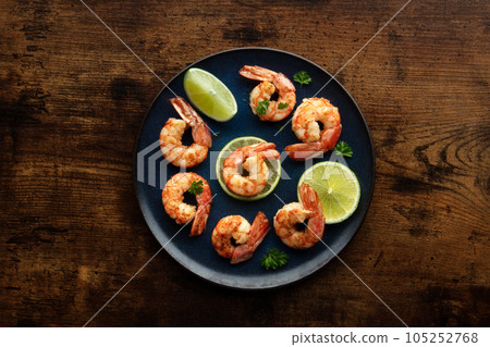 Shrimps, overhead flat lay shot on a rustic wooden table. Cooked shrimp 105252768