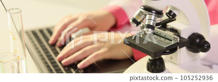 Female hands laboratory typing on keyboard, close-up Female hands laboratory typing on keyboard, close-up 105252936
