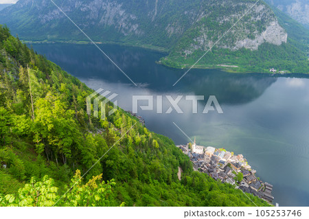 A Beautiful Lakeside View with Stunning Mountain Scenery and Historic Buildings. 105253746