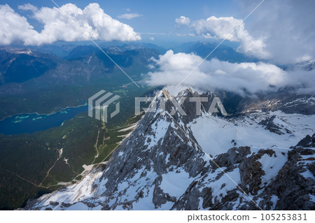 The view from the cable car. Lake, Mountain, Blue sky, white clouds, snow. The view from the cable car. Lake, Mountain, Blue sky, white clouds, snow. 105253831
