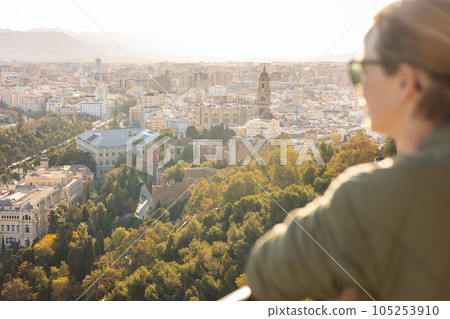 Bolnde female touris enjoying amazing panoramic aerial view of Malaga city historic center, Coste del Sol, Andalucia, Spain. Bolnde female touris enjoying amazing panoramic aerial view of Malaga city historic center, Coste del Sol, Andalucia, Spain. 105253910