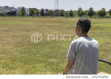 Rear view of a middle-aged man standing alone in the park 105254069