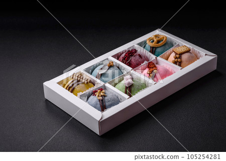 Delicious sweet colorful mochi desserts or ice cream with rice dough and toppings Delicious sweet colorful mochi desserts or ice cream with rice dough and toppings 105254281