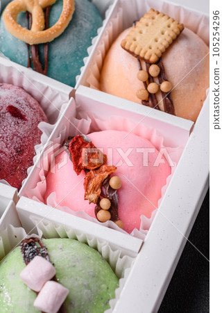 Delicious sweet colorful mochi desserts or ice cream with rice dough and toppings Delicious sweet colorful mochi desserts or ice cream with rice dough and toppings 105254296