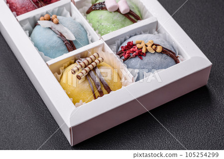Delicious sweet colorful mochi desserts or ice cream with rice dough and toppings Delicious sweet colorful mochi desserts or ice cream with rice dough and toppings 105254299