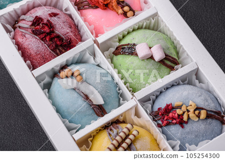 Delicious sweet colorful mochi desserts or ice cream with rice dough and toppings Delicious sweet colorful mochi desserts or ice cream with rice dough and toppings 105254300