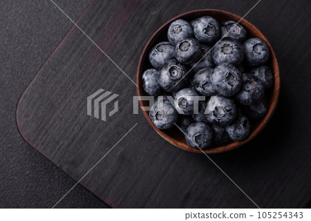 Delicious fresh sweet blueberries in a ceramic bowl. Vegan food 105254343