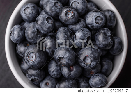 Delicious fresh sweet blueberries in a ceramic bowl. Vegan food 105254347