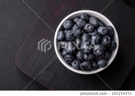 Delicious fresh sweet blueberries in a ceramic bowl. Vegan food 105254351