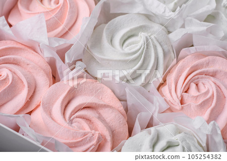Delicious sweet multi-colored marshmallow on a dark concrete background 105254382