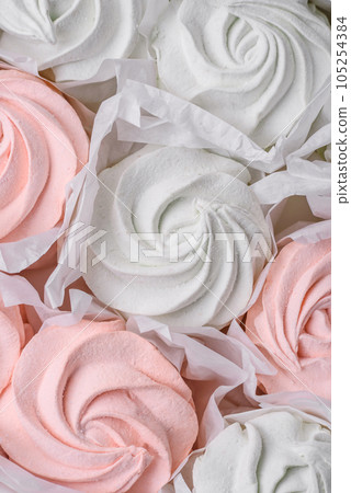 Delicious sweet multi-colored marshmallow on a dark concrete background 105254384