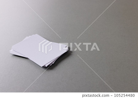 Stack of white business cards with copy space on grey background Stack of white business cards with copy space on grey background 105254480