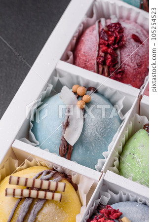 Delicious sweet colorful mochi desserts or ice cream with rice dough and toppings Delicious sweet colorful mochi desserts or ice cream with rice dough and toppings 105254523