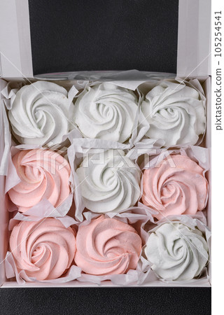 Delicious sweet multi-colored marshmallow on a dark concrete background 105254541