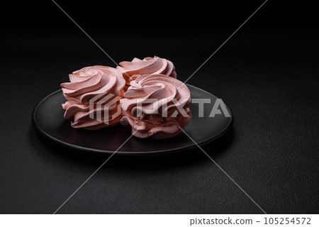 Delicious sweet colored marshmallow on a dark concrete background 105254572