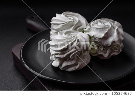 Delicious sweet colored marshmallow on a dark concrete background 105254683