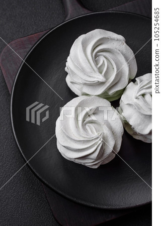 Delicious sweet colored marshmallow on a dark concrete background 105254685