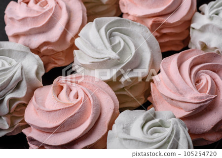 Delicious sweet multi-colored marshmallow on a dark concrete background Delicious sweet multi-colored marshmallow on a dark concrete background 105254720