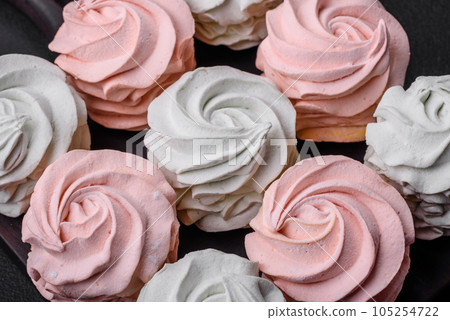 Delicious sweet multi-colored marshmallow on a dark concrete background 105254722
