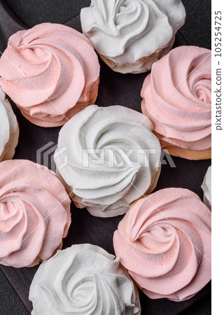 Delicious sweet multi-colored marshmallow on a dark concrete background 105254725