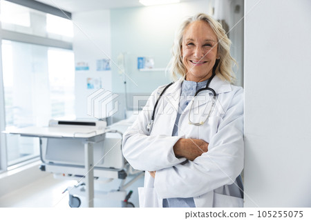 Portrait of happy senior caucasian female doctor wearing lab coat and stethoscope at hospital Portrait of happy senior caucasian female doctor wearing lab coat and stethoscope at hospital 105255075