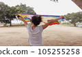 Woman with LGBT flag in the park on pride parade 105255258