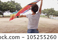 Woman with LGBT flag in the park on pride parade 105255260