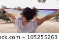 Woman with LGBT flag in the park on pride parade 105255263