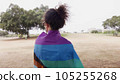 Woman with LGBT flag in the park on pride parade 105255268