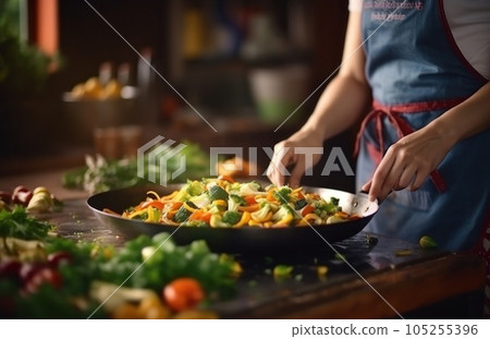 Stirring vegetables in a frying pan 105255396