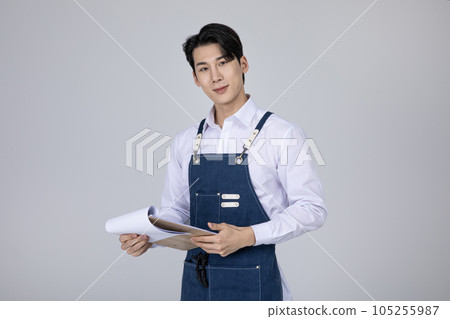 millennials and gen z, korean asian young man holding documents 105255987