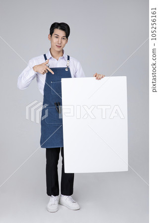 millennials and gen z, korean asian young man holding a frame panel millennials and gen z, korean asian young man holding a frame panel 105256161