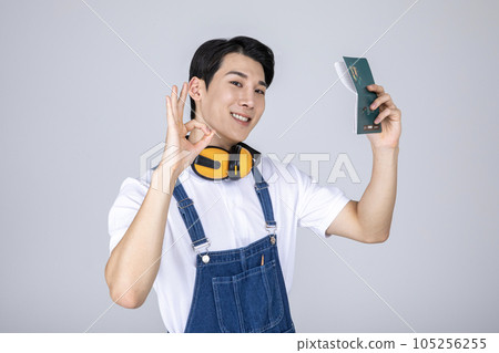 millennials and gen z, korean asian young man carpenter holding a bankbook millennials and gen z, korean asian young man carpenter holding a bankbook 105256255