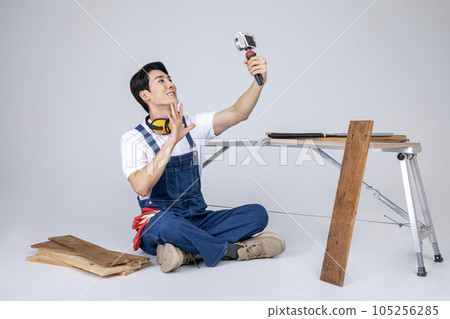millennials and gen z, korean asian young man carpenter filming millennials and gen z, korean asian young man carpenter filming 105256285