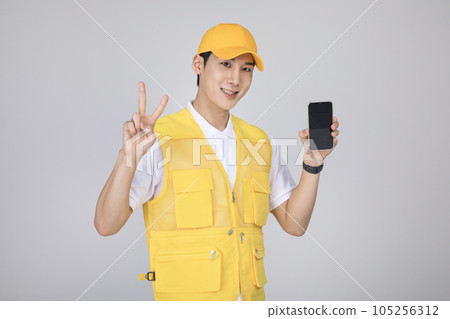millennials and gen z, korean asian young man holding a smartphone with hand motion 105256312