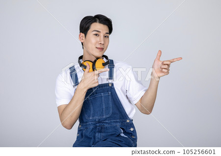 millennials and gen z, korean asian young man carpenter pointing 105256601