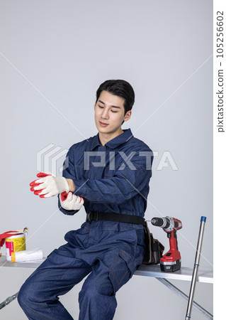 millennials and gen z, korean asian young man with cotton work gloves 105256602