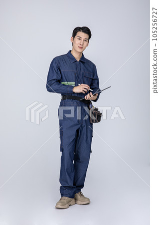 millennials and gen z, korean asian young man, site staff with a tablet pc millennials and gen z, korean asian young man, site staff with a tablet pc 105256727